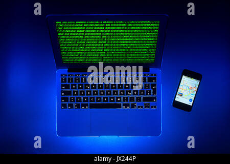 Laptop, symbolic image, cybercrime, computer Crime, computer hacker, data security, tracking, map on smartphone Stock Photo
