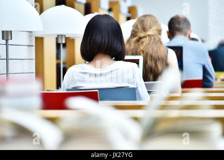Students reading in a public library. Stock Photo