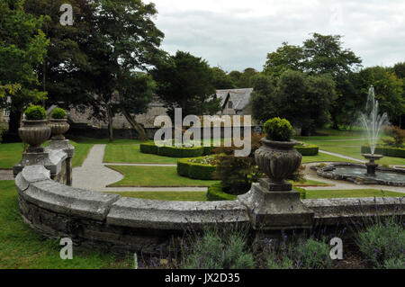 the gardens at prideaux place padstow uk in summer with green gardens and fountains and statuary formally gardening grounds kept weel by gardeners Stock Photo