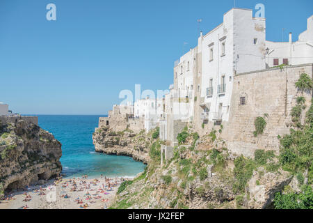 The main beach at Polignano A Mare is nestled in an inlet beneath the Old Town. The famous Red Bull cliff-diving event is held here every year. Stock Photo