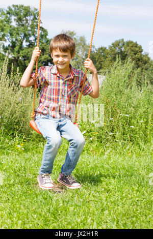 happy-little-kid-swinging-on-
