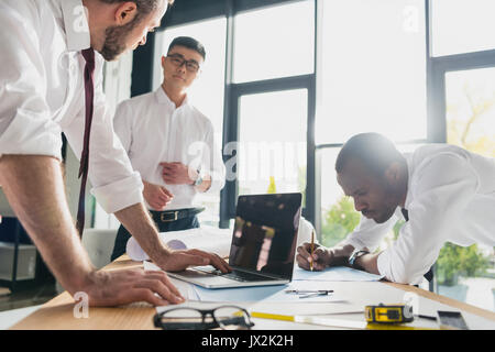 professional architects in formal wear working at modern office, businessmen group Stock Photo