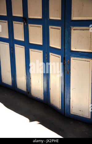 A folding door is a type of door which opens by folding back in sections. Stock Photo