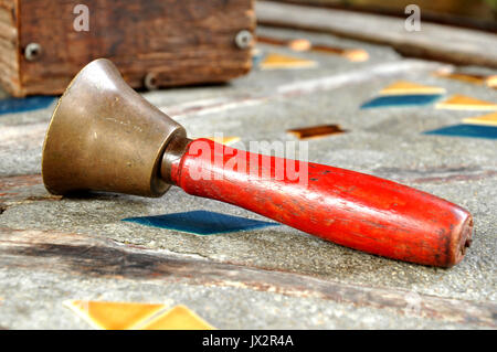 A handbell is a bell designed to be rung by hand. Stock Photo