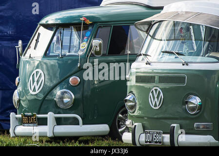 Two fully restored vintage VW Campervans parked next to each other. Stock Photo