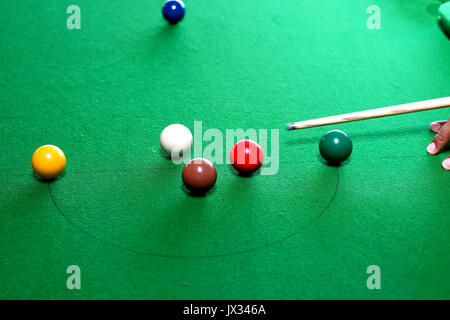snooker game situation with the snooker player being ready to hit the white ball Stock Photo