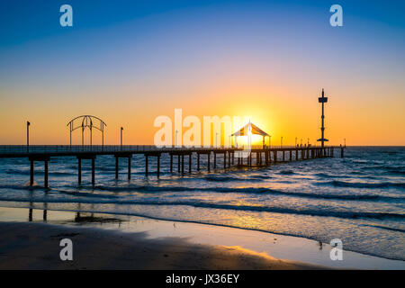 People walking along Brighton Beach jetty at sunset, South Australia Stock Photo