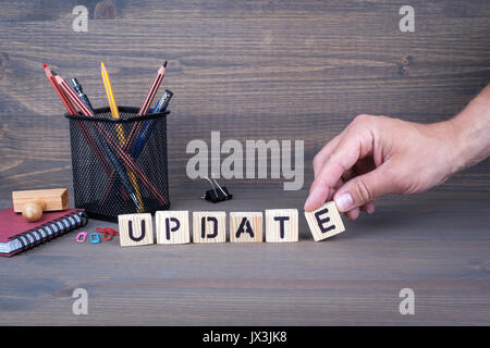 update concept. Wooden letters on dark background Stock Photo