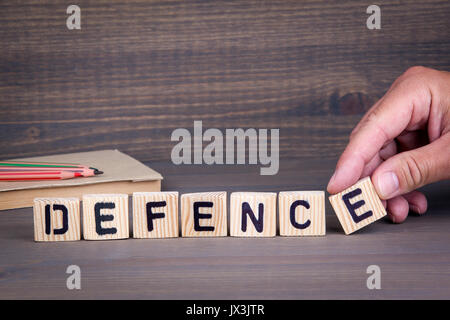 defence. Wooden letters on dark background. Office desk Stock Photo
