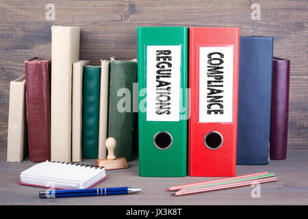 Compliance and Regulations. Binders on desk in the office. Business background. Stock Photo
