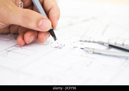 architect working drawing construction plans Stock Photo