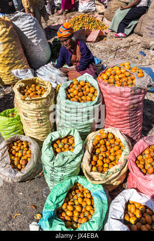 Woman selling fruit in outdoor market, Mawsynram, Meghalaya, India Stock Photo