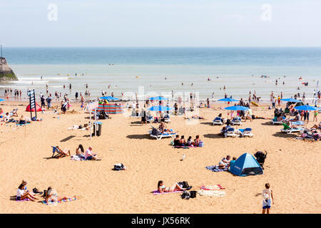 Holiday resort, Broadstairs. Viking bay, the main beach. Beach with many people on sunbathing and paddling in the sea. View out to sea. Stock Photo