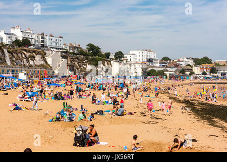 Holiday resort, Broadstairs. Viking bay, the main beach with many people, locals and tourists sunbathing. View along beach. Stock Photo