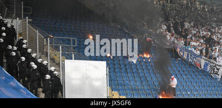 Ostsee Stadium in Rostock, Germany, 14 August 2017. Rostock fans setting seats on fire while police officers stand near by during the DFB Cup match pitting Hansa Rostock vs Hertha BSC at the Ostsee Stadium in Rostock, Germany, 14 August 2017. The game was interrupted at minute 76 due to riots amongst spectators. Credit: dpa picture alliance/Alamy Live News Stock Photo