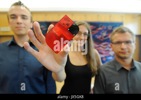 Prague, Czech Republic. 15th August, 2017. CTU (Czech technical university) students Marek Novak (left), Tomas Pikous (right) and Barbora Suchanova (center) present their X.GLU glucometer during the press conference in Prague, Czech Republic, on Tuesday, August 15th, 2017. Students winning the Microsoft Imagine Cup worldwide final with X-GLU. The blood sugar meter has the size of a payment card, into which is inserted a strip of sensory paper with a drop of diabetic blood. Credit: CTK/Alamy Live News Stock Photo