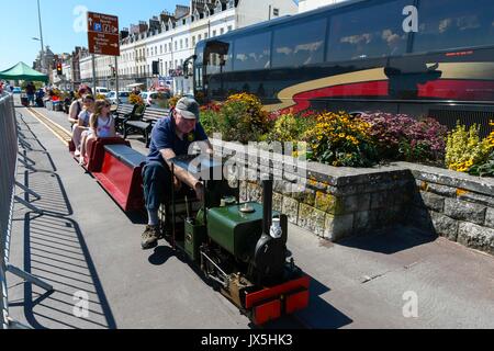 Weymouth, Dorset, UK. 15th Aug, 2017. UK Weather. Holidaymakers enjoy a ride on a modle steam train on the Esplanade under the warm sunshine at the seaside resort of Weymouth in Dorset on the first day of the Carnival. Photo Credit: Graham Hunt/Alamy Live News Stock Photo