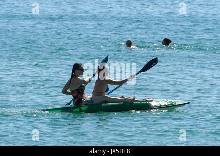 Weymouth, Dorset, UK. 15th Aug, 2017. UK Weather. Holidaymakers on a kayak enjoy the warm sunshine at the seaside resort of Weymouth in Dorset on the first day of the Carnival. Photo Credit: Graham Hunt/Alamy Live News Stock Photo