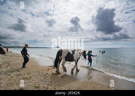 Longrock, near Marazion, Cornwall. 15th August 2017. UK Weather. The sunshine came out this afternoon in south west cornwall. Out in mounts bay people were swimming on horses, including Mea Sucato who flew from New York to Cornwall especially for a birthday treat of going into the waters off Long rock, in front of the iconic St Michaels Mount. Credit: Simon Maycock/Alamy Live News Stock Photo