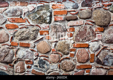 Red bricks and big stones background, decorated blocks texture, wall concrete stone surface Stock Photo