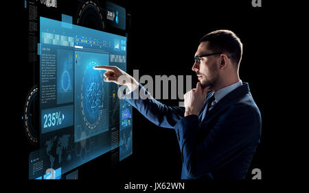 businessman with virtual screen over black Stock Photo