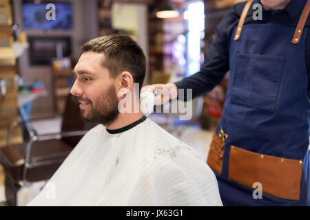 barber with brush cleaning male neck at barbershop Stock Photo