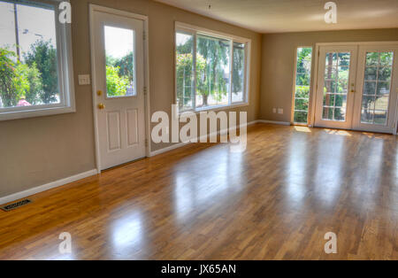 Interior empty living room with no furniture and no people.  Residential with front door and French glass doors and hardwood floors. Stock Photo