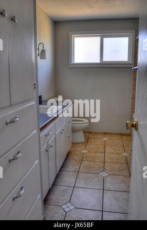Interior bathroom residential room.  Small white and light gray color pallette. Stock Photo