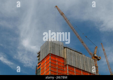 Top of a high rise under construction against blue skies. Stock Photo