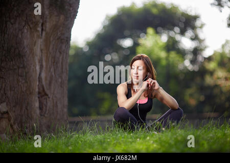 Woman enjoying music while resting Stock Photo