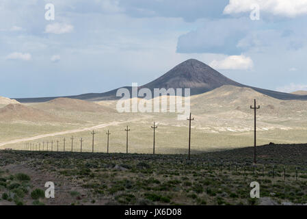 Line of utility poles near Saulsbury Summit in the Nevada desert. Stock Photo