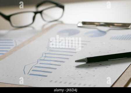 Checking financial reports paperwork and Business  Teamwork on Preparing report Blue graphs  glasses Stock Photo