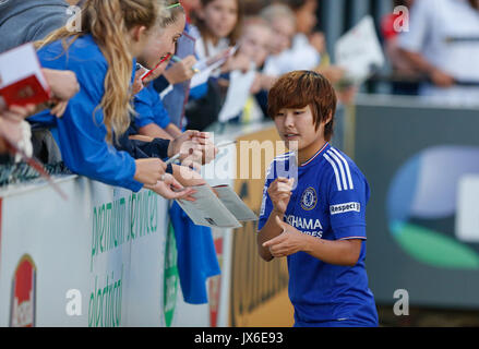 Ji So-Yun of Chelsea Ladies signs autographs for supporters during the FAWSL match between Arsenal Ladies and Chelsea Ladies at Meadow Park, Borehamwo Stock Photo