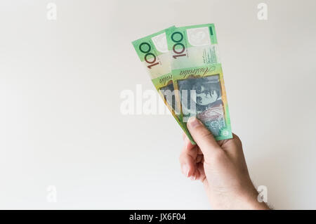 Man holding two hundred Australian Dollar banknotes in his hand Stock Photo