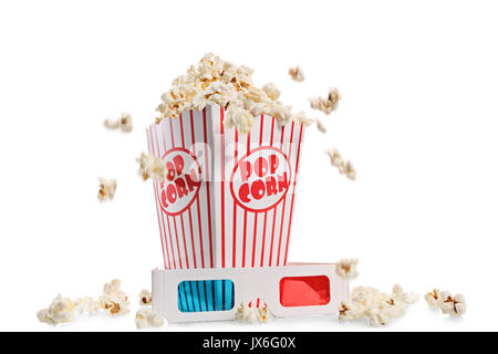 Box overflowing with popcorn and a pair of 3D glasses isolated on white background Stock Photo