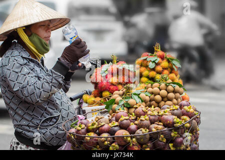 Saigon, Vietnam - June 30, 2017: Woman selling fruit on street, Saigon, Vietnam. Stock Photo