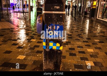 Partially ripped safety sign on lamp post in central Glasgow. Stock Photo
