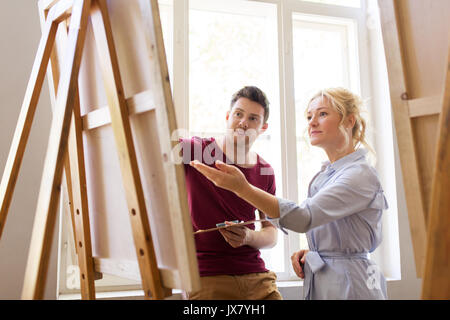 artists with palette and easel at art school Stock Photo