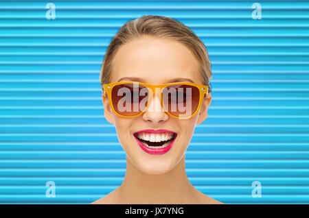 happy teenage girl or woman face in shades Stock Photo
