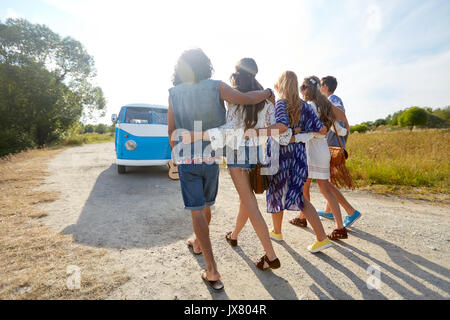 smiling happy young hippie friends at minivan car Stock Photo