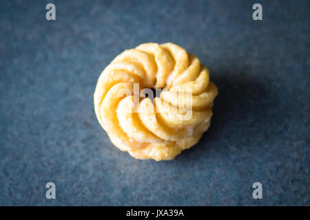 A honey cruller donut from Tim Hortons, a popular Canadian fast food restaurant and donut shop. Stock Photo