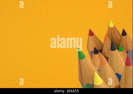 bunch of colored pencils on yellow background Stock Photo