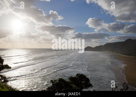 Sun beaming down on Piha Beach New Zealand.  Photo was taken from Lion Rock Stock Photo