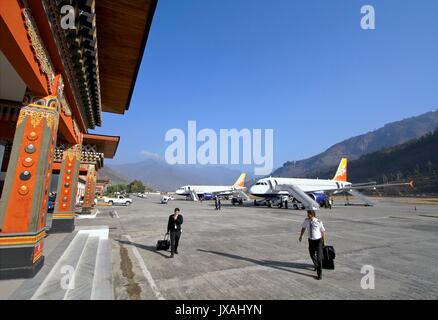 Thimphu, Bhutan - November 06, 2012: Unidentified pilots with baggage walking in Paro airport after landing with Airbus A319 from Drukair airline, Par Stock Photo