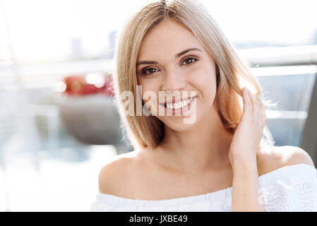 Attractive pretty woman fixing her hair Stock Photo