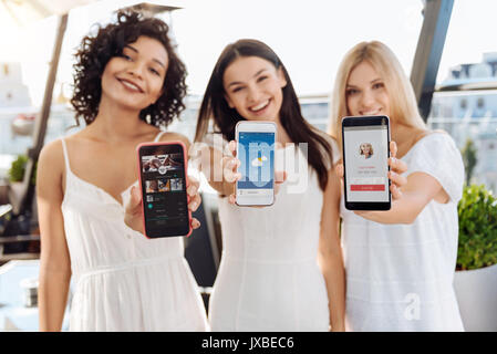 Selective focus of three modern smartphones Stock Photo