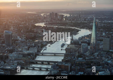 General aerial view of The Shard, Tower Bridge, 20 Fenchurch street, nicknamed the walkie talkie building, central London and Canary Wharf (background) at sunrise. Stock Photo