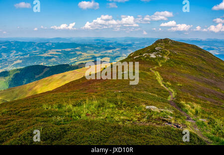 path through the grassy meadows on top of mountain ridge. Classic late summer travel background in Carpathian alps. Wonderful evening weather with blu Stock Photo