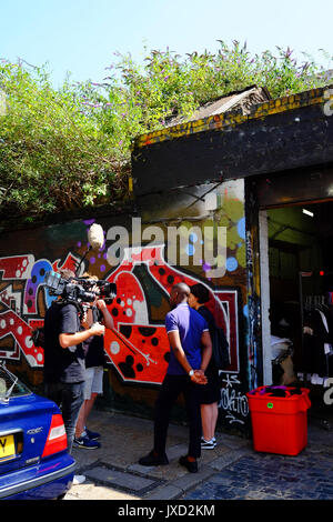 Billie JD Porter interviews an artist for television in Shoreditch, in the East End of London Billie JD Porter interviews an artist for television in Shoreditch, in the East End of London