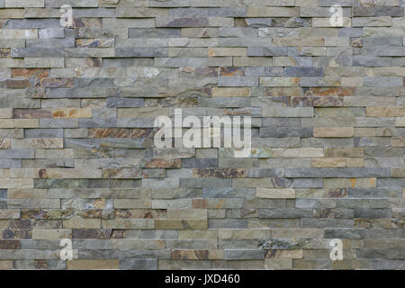 Natural stone cladding in grey, brown golden and silver colour. Stock Photo